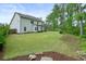 Spacious, grassy backyard surrounded by trees for added privacy at 242 Fieldbrook Xing, Canton, GA 30115