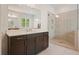 Bright bathroom featuring a separate glass shower, and dark wood cabinets at 242 Fieldbrook Xing, Canton, GA 30115