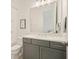 Bathroom with grey vanity, white countertop, a large mirror, and a shower with white subway tile at 242 Fieldbrook Xing, Canton, GA 30115