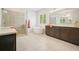 Bright bathroom featuring a soaking tub, separate shower, and double vanity with dark wood cabinets at 242 Fieldbrook Xing, Canton, GA 30115