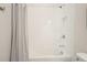 Bright bathroom featuring a shower-over-tub with white tile surround and shower niche at 242 Fieldbrook Xing, Canton, GA 30115