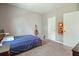 Bedroom features light-colored walls, carpet, and simple décor with guitar on the wall at 242 Fieldbrook Xing, Canton, GA 30115