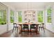 Bright dining area featuring a wooden table, seating for six, and views of the green outdoors at 242 Fieldbrook Xing, Canton, GA 30115