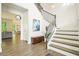 Bright foyer with hardwood floors, staircase, and stylish decor at 242 Fieldbrook Xing, Canton, GA 30115