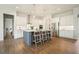 Modern kitchen with a central island with barstool seating, stainless steel appliances, and hardwood floors at 242 Fieldbrook Xing, Canton, GA 30115