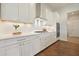 Well-appointed kitchen features white cabinets, stainless steel appliances, and modern backsplash at 242 Fieldbrook Xing, Canton, GA 30115