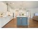 Bright, open kitchen with island, white cabinets, quartz countertops, and stainless steel appliances at 242 Fieldbrook Xing, Canton, GA 30115
