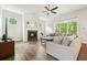 Cozy living room featuring a fireplace and large windows overlooking the backyard at 242 Fieldbrook Xing, Canton, GA 30115