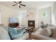 Inviting living room with a fireplace, ceiling fan, and comfortable seating at 242 Fieldbrook Xing, Canton, GA 30115