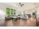 Bright living room features a large window overlooking the yard, comfortable sofas, hardwood floor and an attractive coffee table at 242 Fieldbrook Xing, Canton, GA 30115