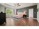 Spacious main bedroom with tray ceiling, hardwood floors, and a large window at 242 Fieldbrook Xing, Canton, GA 30115