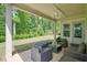 Covered back patio with outdoor furniture and a view of the lush backyard at 242 Fieldbrook Xing, Canton, GA 30115