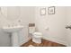 Stylish powder room with pedestal sink, decorative mirror, and modern fixtures at 242 Fieldbrook Xing, Canton, GA 30115