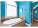 Bright bathroom features a soaking tub and large window, perfect for relaxation and natural light at 2853 N Thompson Ne Rd, Brookhaven, GA 30319