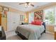 Cozy bedroom features two windows for ample light, ceiling fan, closet, and a comfortable bed at 2853 N Thompson Ne Rd, Brookhaven, GA 30319