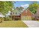 Charming two-story home with a well-manicured lawn and a three-car garage at 2853 N Thompson Ne Rd, Brookhaven, GA 30319