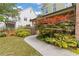 Walkway leading to a home's entrance, surrounded by lush landscaping and a vibrant Japanese maple at 2853 N Thompson Ne Rd, Brookhaven, GA 30319