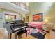 Spacious living room with hardwood floors, fireplace, and piano with a view of the second floor at 2853 N Thompson Ne Rd, Brookhaven, GA 30319