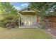 Charming outbuilding with a covered porch, providing a cozy space in the landscaped backyard at 2853 N Thompson Ne Rd, Brookhaven, GA 30319