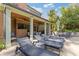 Relaxing outdoor patio featuring lounge chairs, a covered dining area, and a brick exterior with TV at 2853 N Thompson Ne Rd, Brookhaven, GA 30319