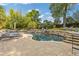 Inviting backyard pool area with stone coping, cascading waterfall, lounge chairs, and lush landscaping at 2853 N Thompson Ne Rd, Brookhaven, GA 30319