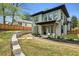 A patio in the backyard of a two-story home, with retaining walls and a lawn at 1010 Violet # A, Atlanta, GA 30310