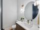 Elegant powder room with round mirror, modern lighting fixture, and unique vessel sink at 1010 Violet # A, Atlanta, GA 30310