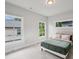 Bright bedroom with light grey walls, a comfortable bed, and three windows providing natural light at 1010 Violet # A, Atlanta, GA 30310