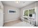 Bright bedroom featuring neutral walls, carpet floors, and a workspace in front of large windows with sheer curtains at 1010 Violet # A, Atlanta, GA 30310