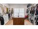 Spacious walk-in closet with custom shelving and ample storage, centered with a wood table at 1010 Violet # A, Atlanta, GA 30310