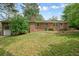 Exterior view of a brick house with a well-maintained lawn and a patio area for outdoor living at 2350 Maxine Se Dr, Marietta, GA 30067