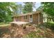 Back exterior showcasing a brick house with a patio, perfect for outdoor enjoyment and relaxation at 2350 Maxine Se Dr, Marietta, GA 30067