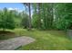 Serene backyard with lush greenery and ample space for outdoor activities and relaxation at 2350 Maxine Se Dr, Marietta, GA 30067