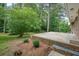A backyard with a brick patio and mature trees that offer ample shade at 2350 Maxine Se Dr, Marietta, GA 30067