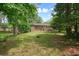 Spacious backyard featuring a well-maintained lawn, mature trees, and a brick exterior home, perfect for outdoor enjoyment at 2350 Maxine Se Dr, Marietta, GA 30067