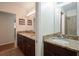 Bathroom with double sinks, granite countertop, and dark wood cabinetry. Second sink featured in adjacent area at 2350 Maxine Se Dr, Marietta, GA 30067