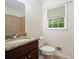 Bathroom featuring granite countertop and tile wall near window, toilet, and baseboard heater at 2350 Maxine Se Dr, Marietta, GA 30067