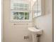 Bathroom featuring a pedestal sink, modern faucet, and a window with natural light at 2350 Maxine Se Dr, Marietta, GA 30067