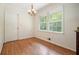 Bright dining room featuring hardwood floors, a modern chandelier, and natural light at 2350 Maxine Se Dr, Marietta, GA 30067