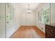Cozy dining room with hardwood floors, classic lighting, and views of the outdoors at 2350 Maxine Se Dr, Marietta, GA 30067
