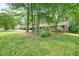 Lovely single-story brick home surrounded by mature trees and a lush green lawn, offering a peaceful and private setting at 2350 Maxine Se Dr, Marietta, GA 30067