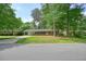 Inviting single-story brick home with a carport, well-manicured lawn, and mature trees creating a serene setting at 2350 Maxine Se Dr, Marietta, GA 30067