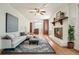 Bright living room with hardwood floors, fireplace, stylish decor, and open layout to the kitchen at 2350 Maxine Se Dr, Marietta, GA 30067