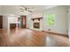 Open-concept living room with a fireplace, hardwood floors, and stainless steel appliances at 2350 Maxine Se Dr, Marietta, GA 30067