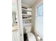 This bathroom features built-in shelves above the toilet for linens and decorative items at 3701 Shallowford Rd, Marietta, GA 30062