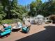 Outdoor deck featuring seating areas, including chairs and a table with umbrellas at 3701 Shallowford Rd, Marietta, GA 30062