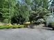 Professionally landscaped front yard with mature trees and manicured shrubs, enhancing curb appeal at 3701 Shallowford Rd, Marietta, GA 30062