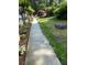 Concrete walkway flanked by well-maintained landscaping and greenery at 3701 Shallowford Rd, Marietta, GA 30062