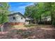 View of the home's exterior and wooden patio in the backyard at 3812 Stonewall Nw Dr, Kennesaw, GA 30152