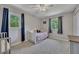 Cozy bedroom with neutral walls, carpeted floors, ceiling fan, and windows providing natural light at 3812 Stonewall Nw Dr, Kennesaw, GA 30152